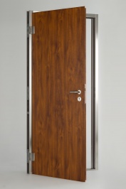 WE15 door leaf in Medium Oak wood effect steel with stainless furniture. WE15 frame and threshold in brushed stainless steel. Other options are available.